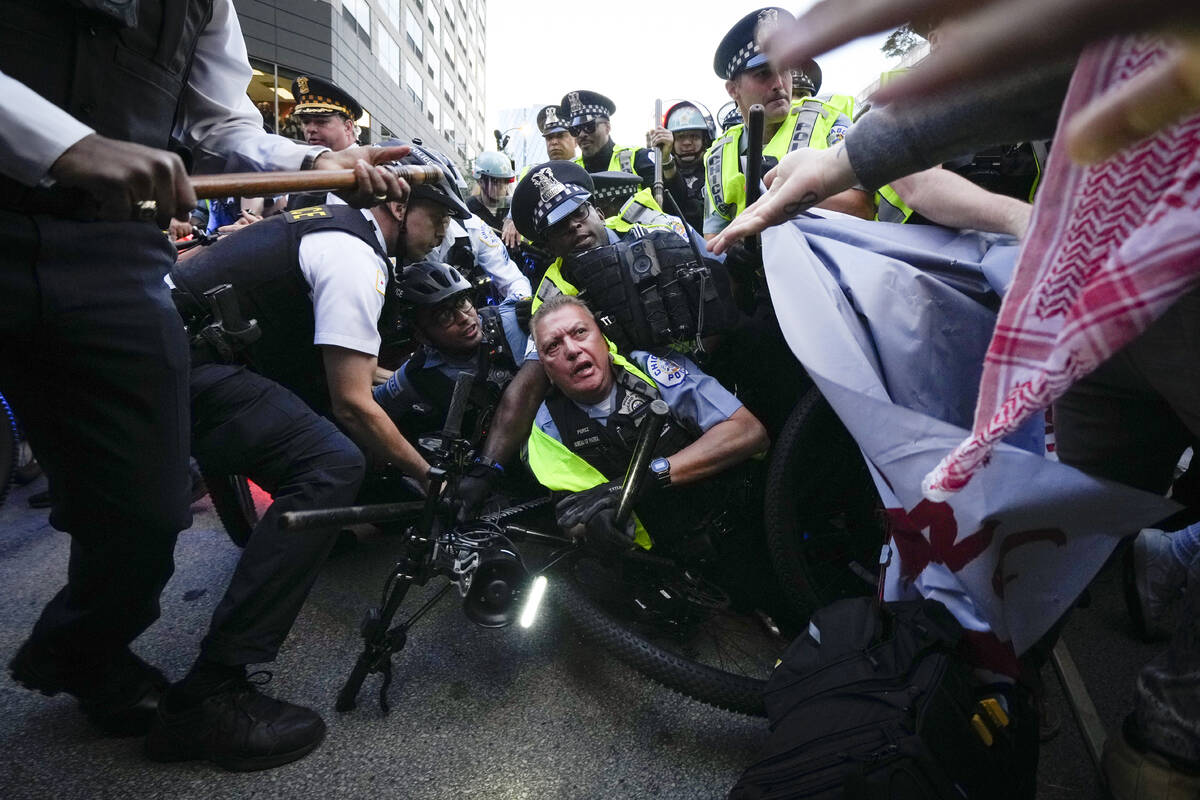 Demonstrators clash with police near the Israeli Consulate during the Democratic National Conve ...