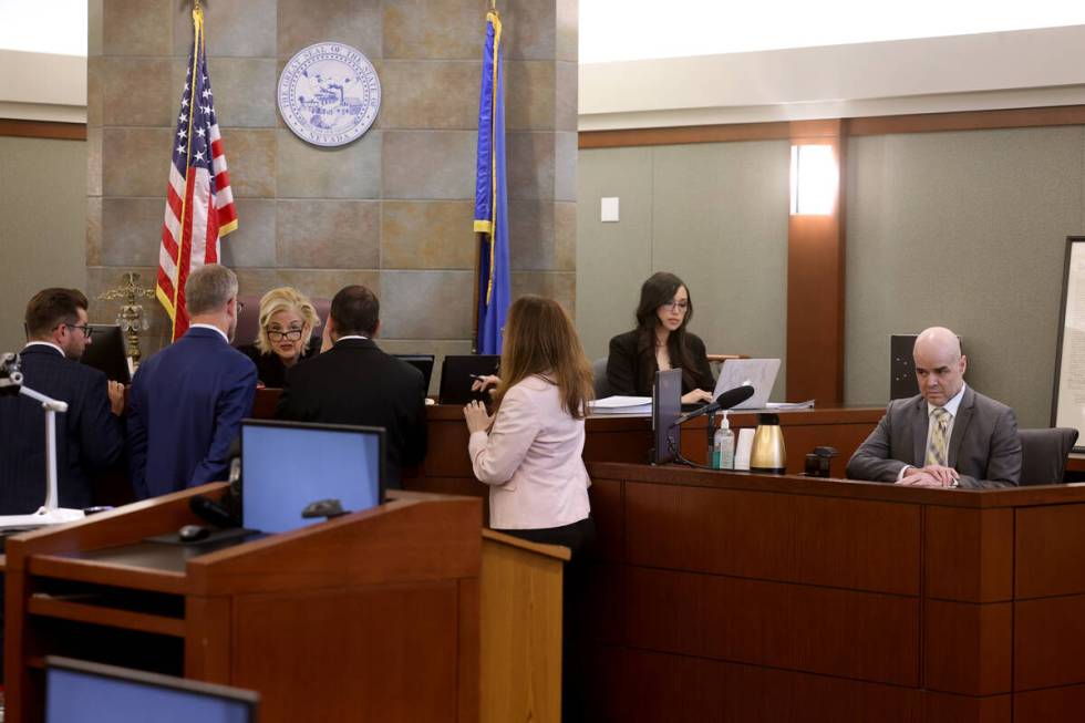 District Judge Michelle Leavitt speaks to attorneys as Robert Telles waits on the witness stand ...