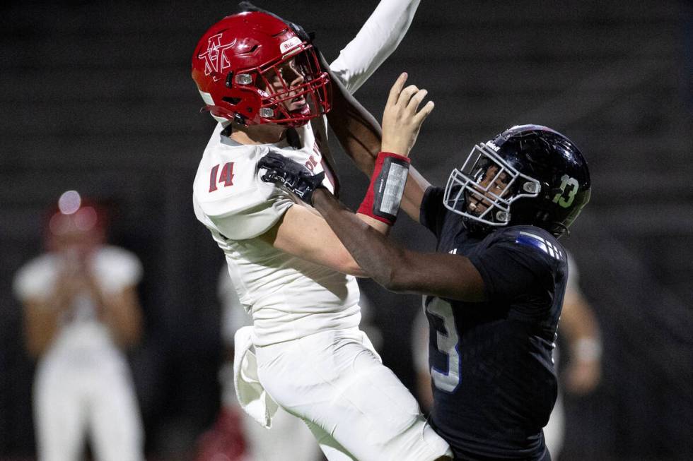 Arbor View quarterback Alonzo Balderrama (14) attempts to throw while Desert Pines linebacker S ...