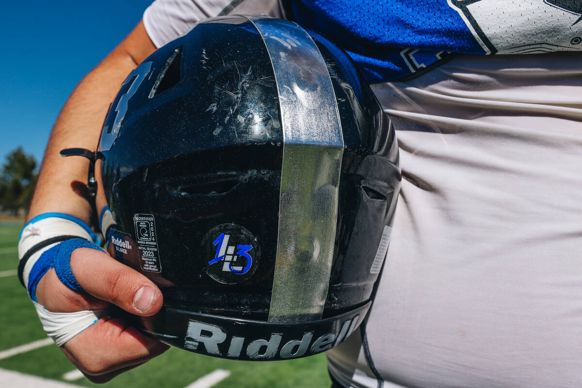 Desert Pines football player Gabe Gough holds onto his helmet during a practice at Desert Pines ...