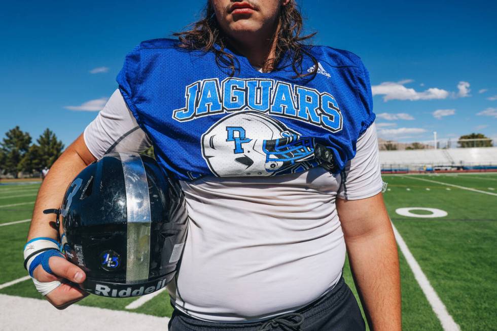 Desert Pines football player Gabe Gough holds onto his helmet during a practice at Desert Pines ...