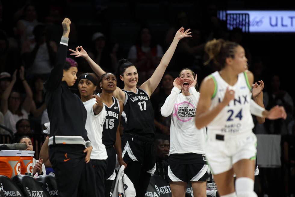 The Las Vegas Aces bench cheers after their team scored during the first half of a WNBA basketb ...