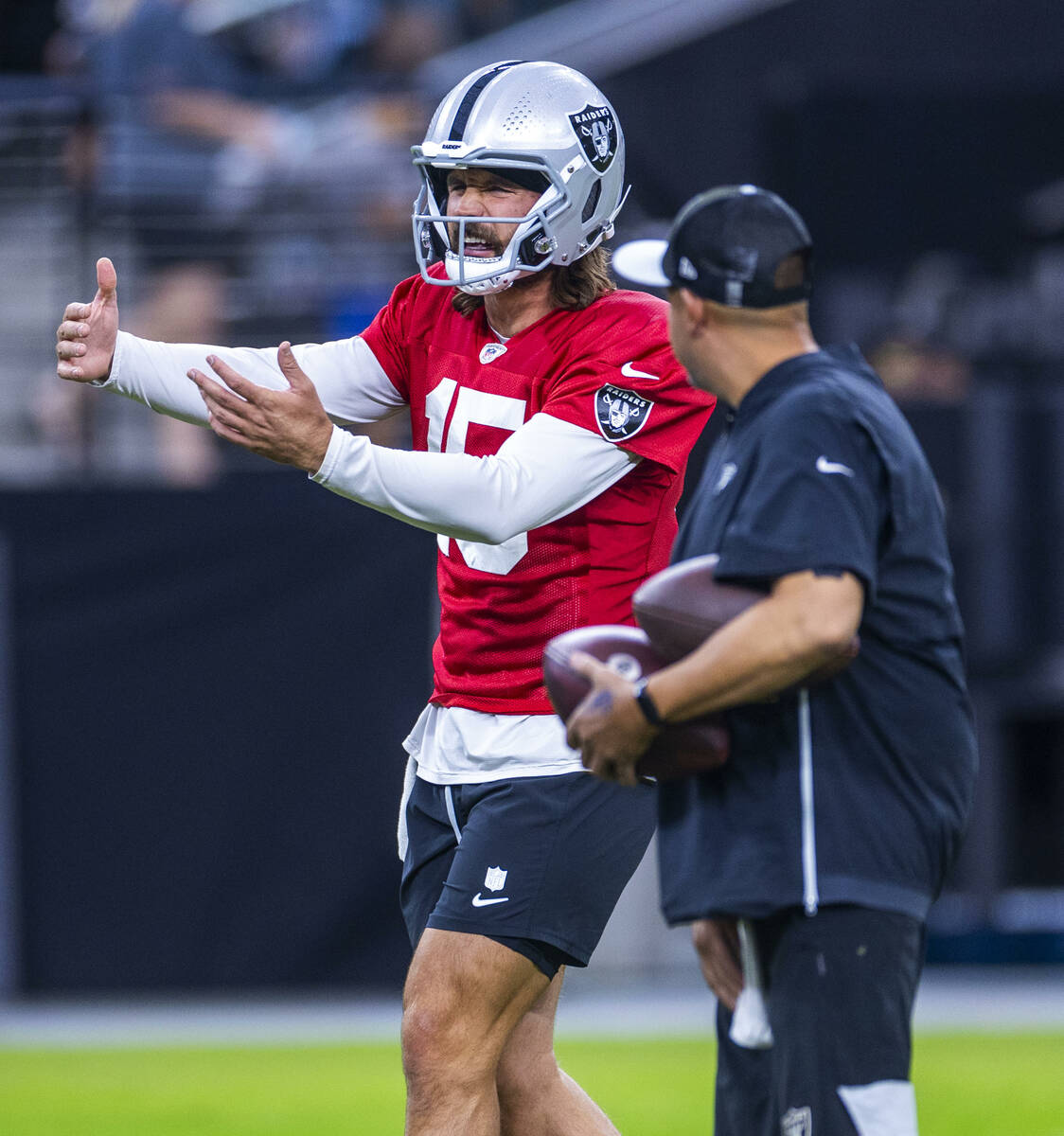 Raiders quarterback Gardner Minshew (15) directs a teammate on a play during an open practice a ...