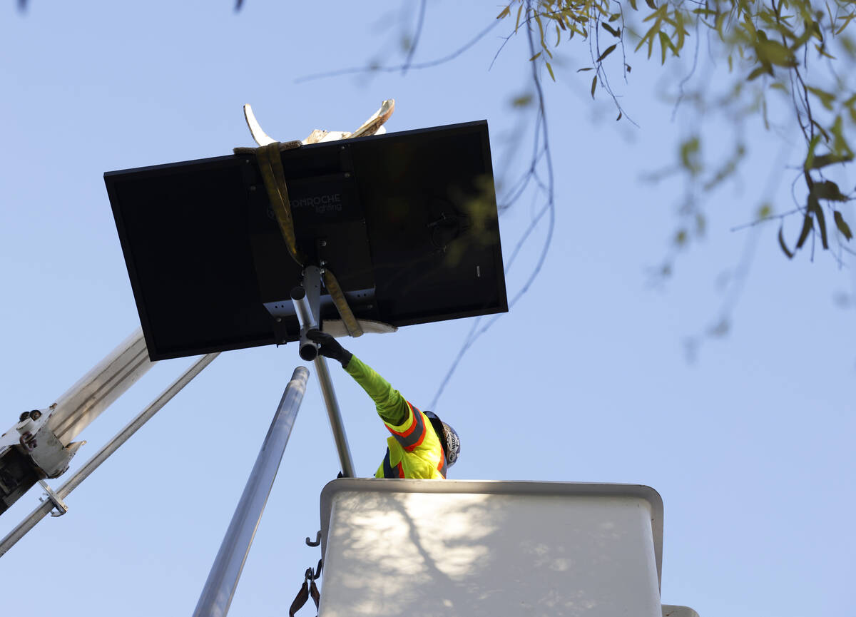 A worker from Clark County’s Public Works Department installs one of the 12 new solar street ...