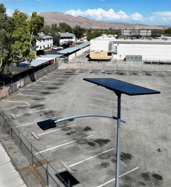 One of 12 new solar streetlights is seen at the corner of East St. Louis Avenue and Palm Street ...