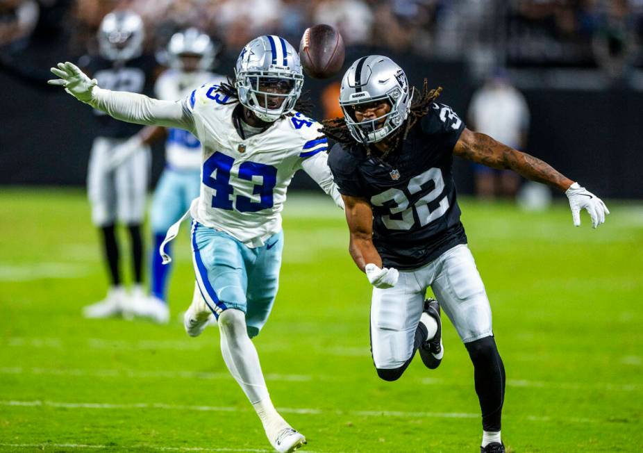 Raiders wide receiver Tyreik McAllister (32) and Dallas Cowboys cornerback Kemon Hall (43) both ...