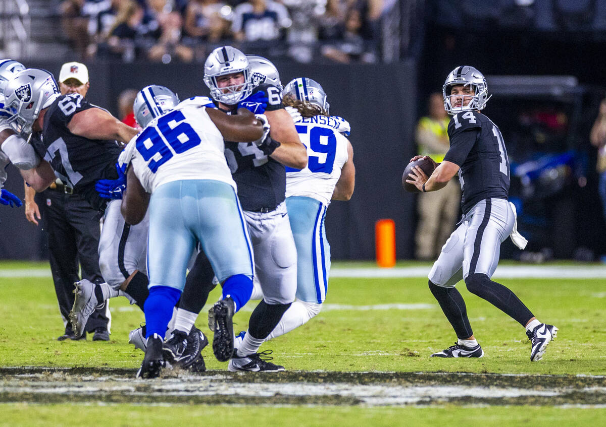 Raiders quarterback Carter Bradley (14) looks to pass against the Dallas Cowboys during the sec ...