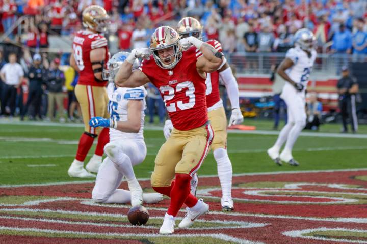 San Francisco 49ers' running back Christian McCaffrey (23) reacts after scoring a touchdown aga ...