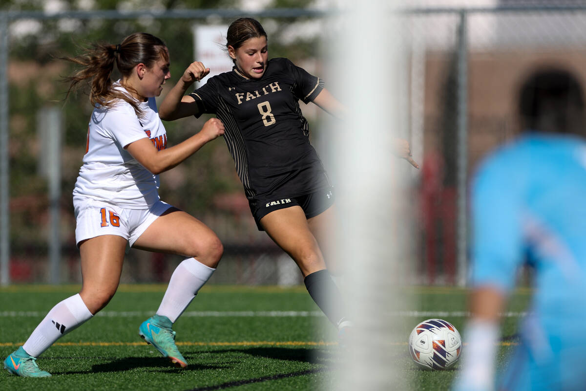 Faith Lutheran’s Olivia Stark (8) attempts a goal while Bishop Gorman’s Grace Yag ...