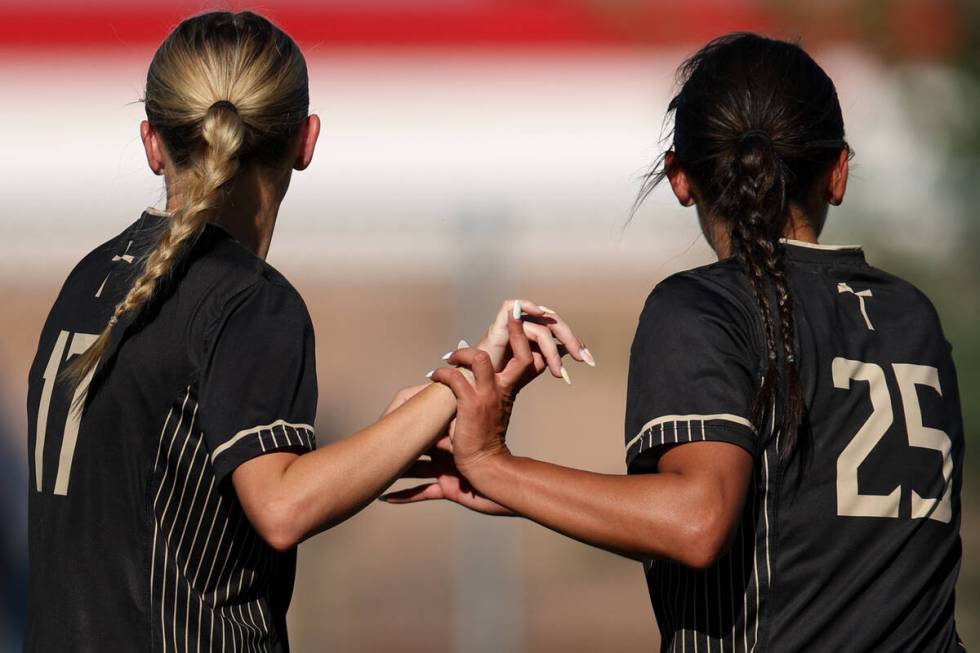 Faith Lutheran’s Julia Anfinson (17) and Riley Renteria (52) celebrate Renteria’s ...