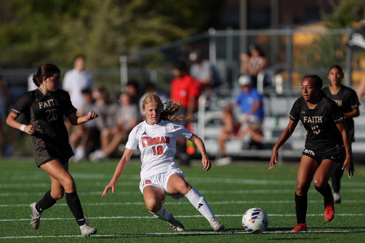 Bishop Gorman’s Grace Yager (18) passes up the field while Faith Lutheran’s Kenne ...