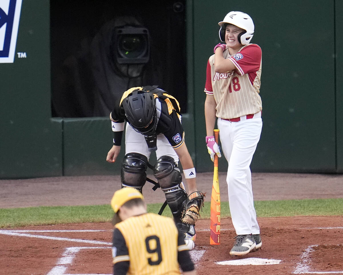 Henderson, Nev.'s Wyatt Erickson (18) reacts as he heads to first base after being hit by a pit ...