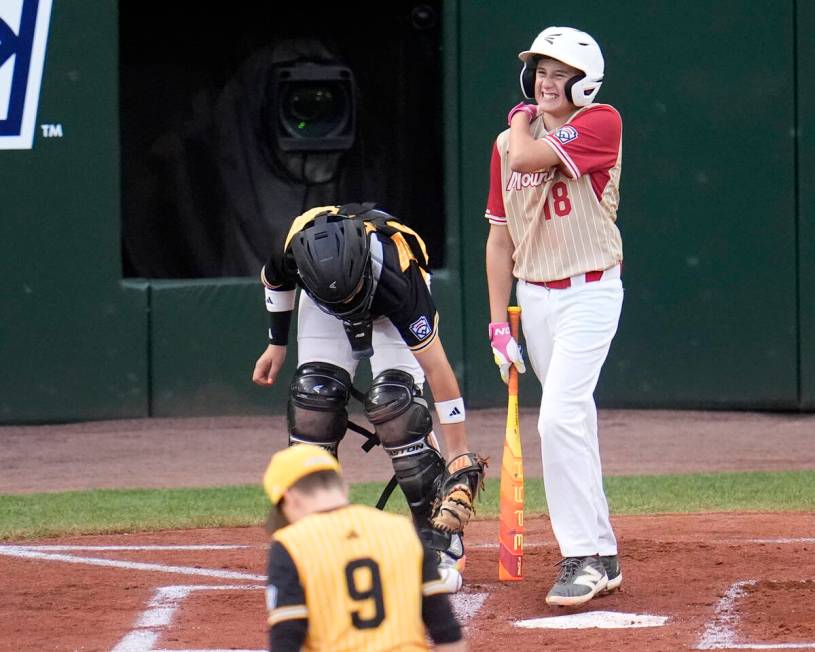 Henderson, Nev.'s Wyatt Erickson (18) reacts as he heads to first base after being hit by a pit ...