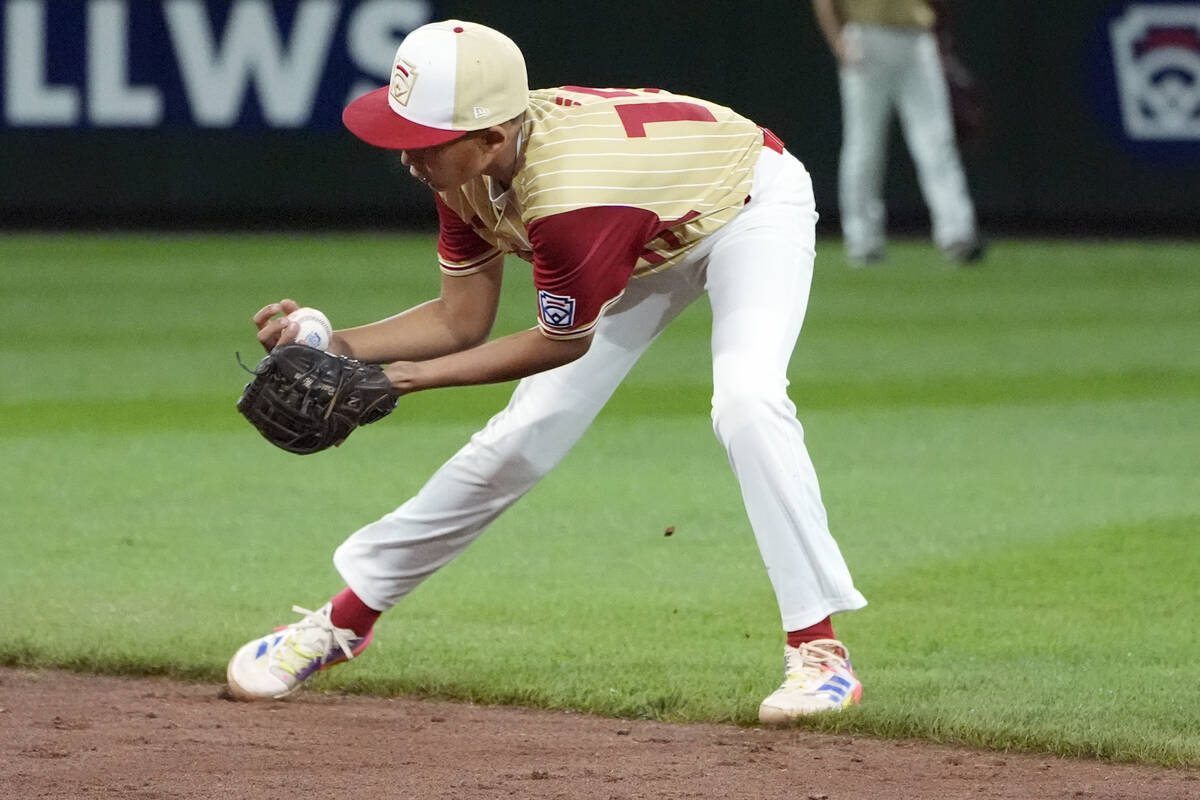 Henderson, Nev. shortstop Russell McGee (17) fields a ball up the middle hit by Lake Mary, Fla. ...