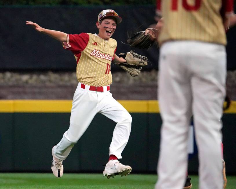 Henderson, Nev.'s Dominic Laino, left, celebrates as he returns to the dugout after making an i ...