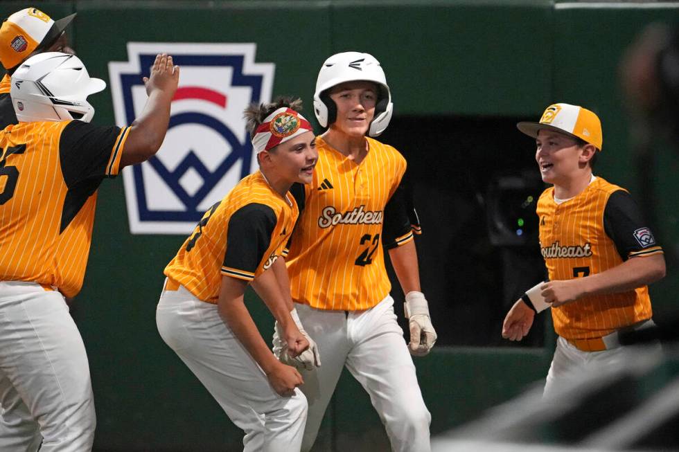 Lake Mary, Fla.'s Garrett Rohozen (22) returns to the dugout after hitting a solo home run off ...