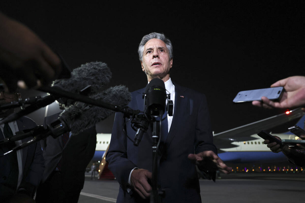 U.S. Secretary of State Antony Blinken speaks to reporters on the tarmac in Doha, Qatar, on Aug ...