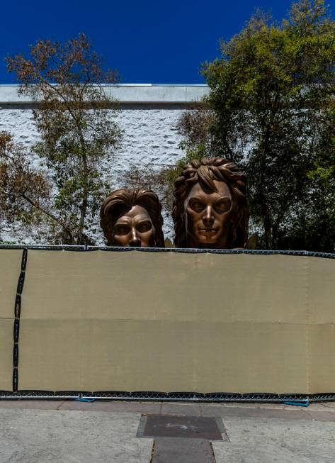 Siegfried and Roy statues peer over the fencing as demolition continues at the Mirage on Thursd ...