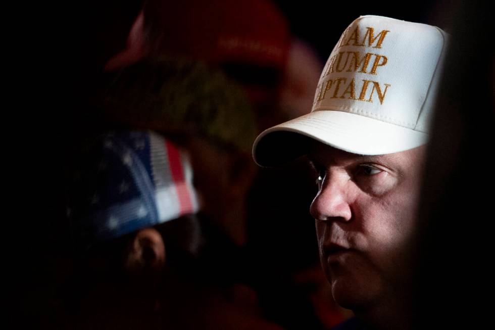 A supporter of Republican presidential nominee former President Donald Trump waits for the arri ...