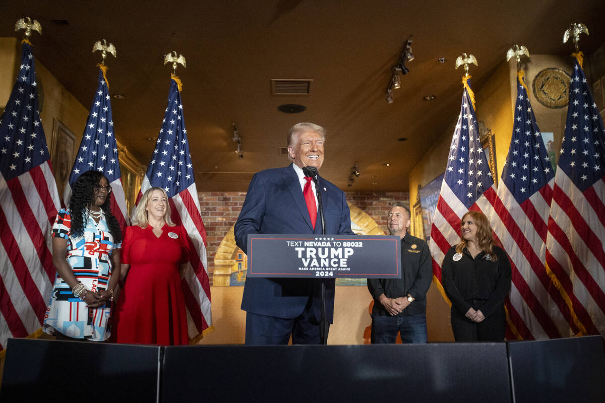 Republican presidential nominee former President Donald Trump smiles as he arrives at the podiu ...