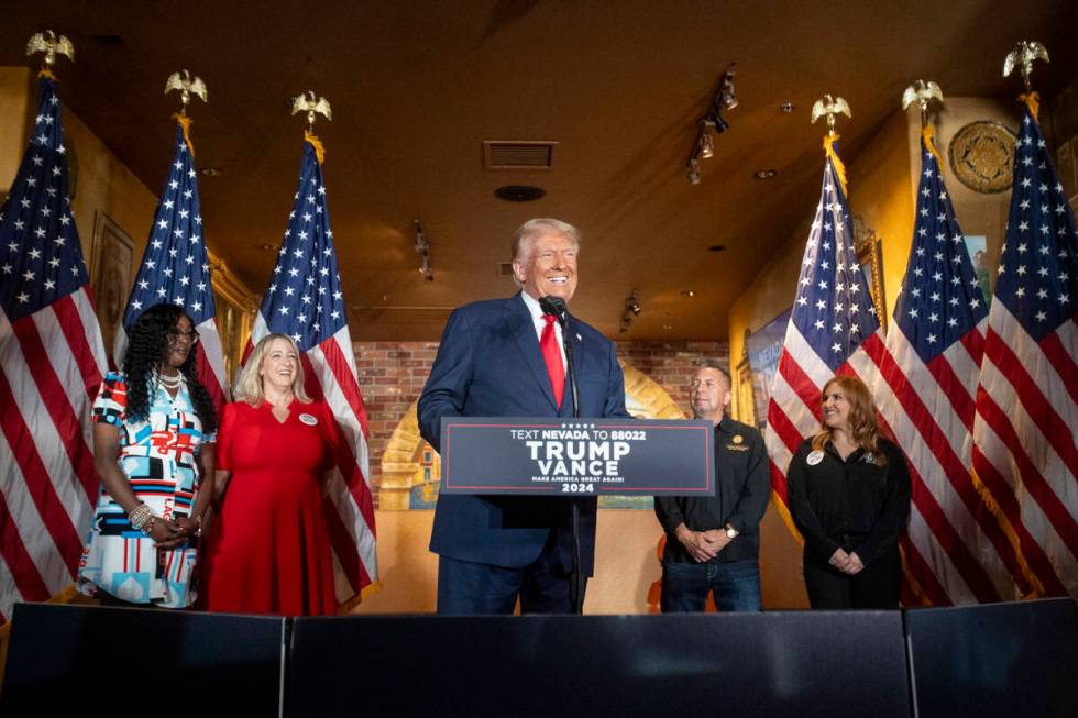 Republican presidential nominee former President Donald Trump smiles as he arrives at the podiu ...