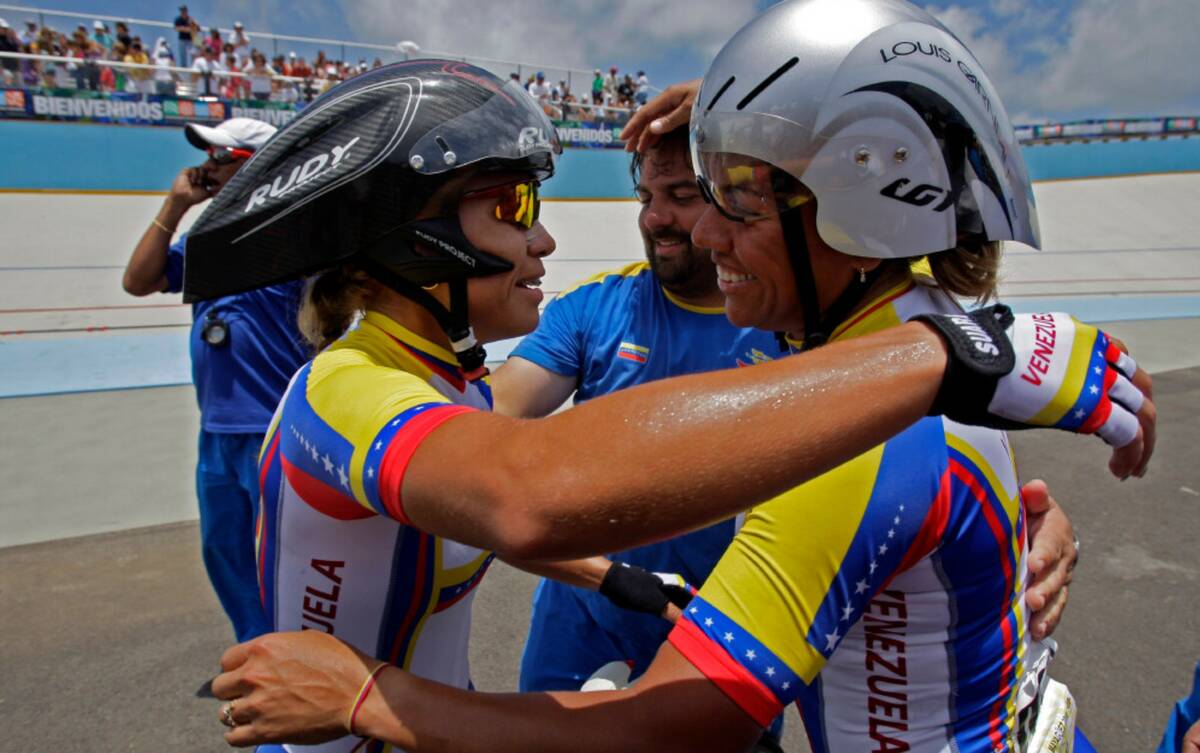 Venezuela's Daniela Larreal, right, and Angie Gonzalez celebrate after beating Colombia in the ...