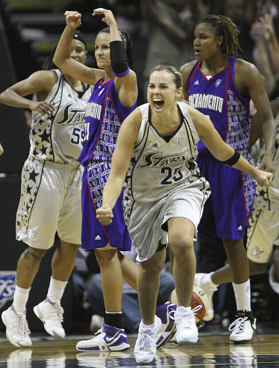 San Antonio Silver Stars' Becky Hammon (25) celebrates as Sacramento Monarchs' Ticha Penicheiro ...