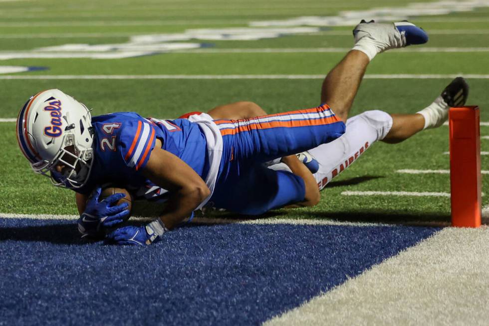 Bishop Gorman running back Myles Norman (24) tumbles into the end zone for a touchdown over Kah ...