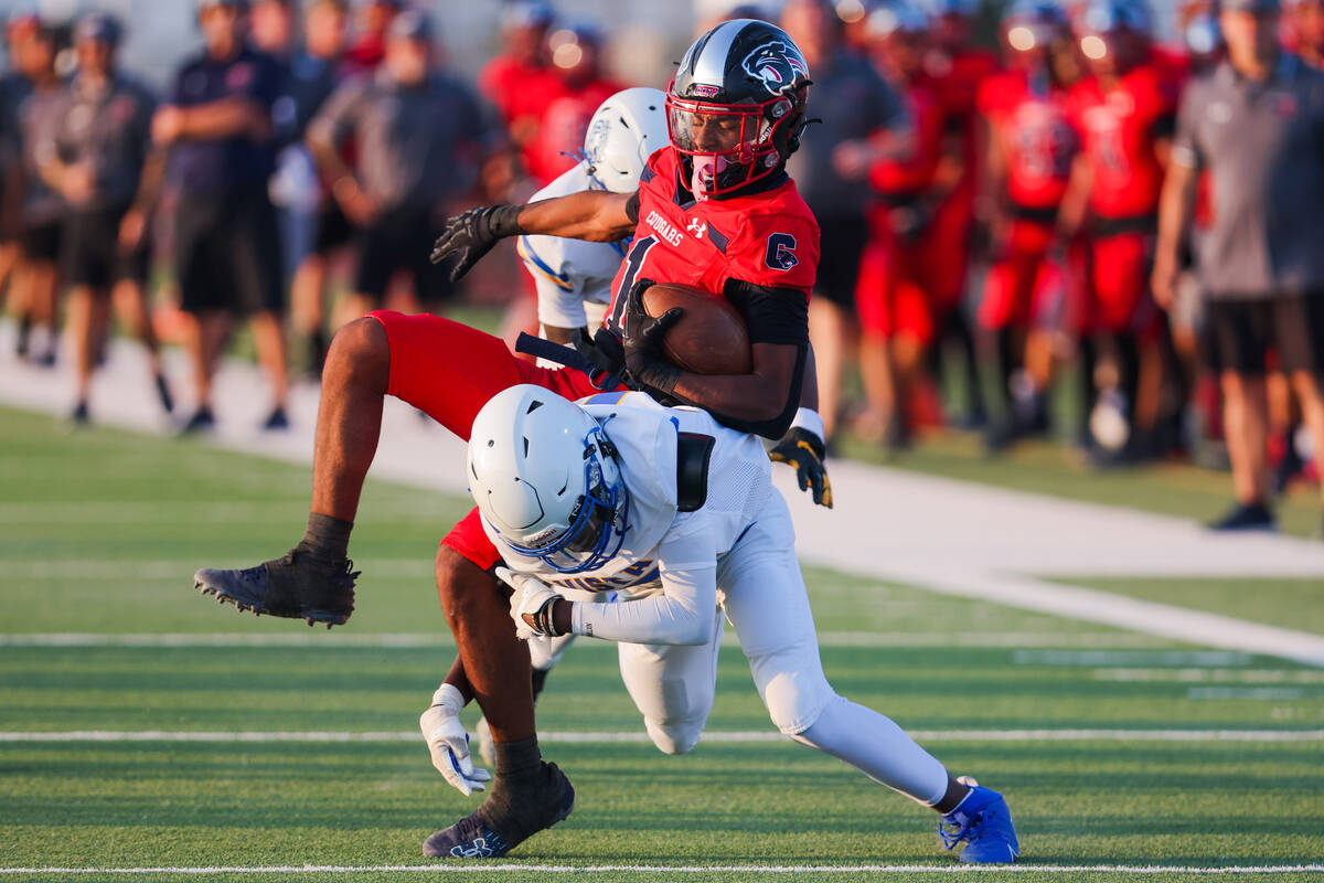 Coronado’s Marquesion Floyde (1) falls as Sierra Vista cornerback Jodi Nestan (12) goes ...