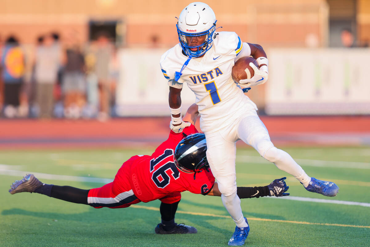 Sierra Vista slotback Adonis Vaughn (1) escapes Coronado wide receiver Layton Bachhuber (16) du ...