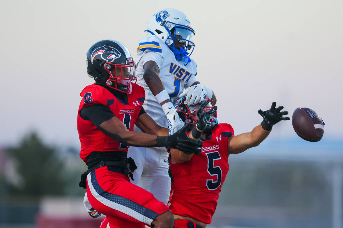 The ball escapes the grasp of Coronado’s Derek Hurley (5) and Marquesion Floyde (1) as t ...