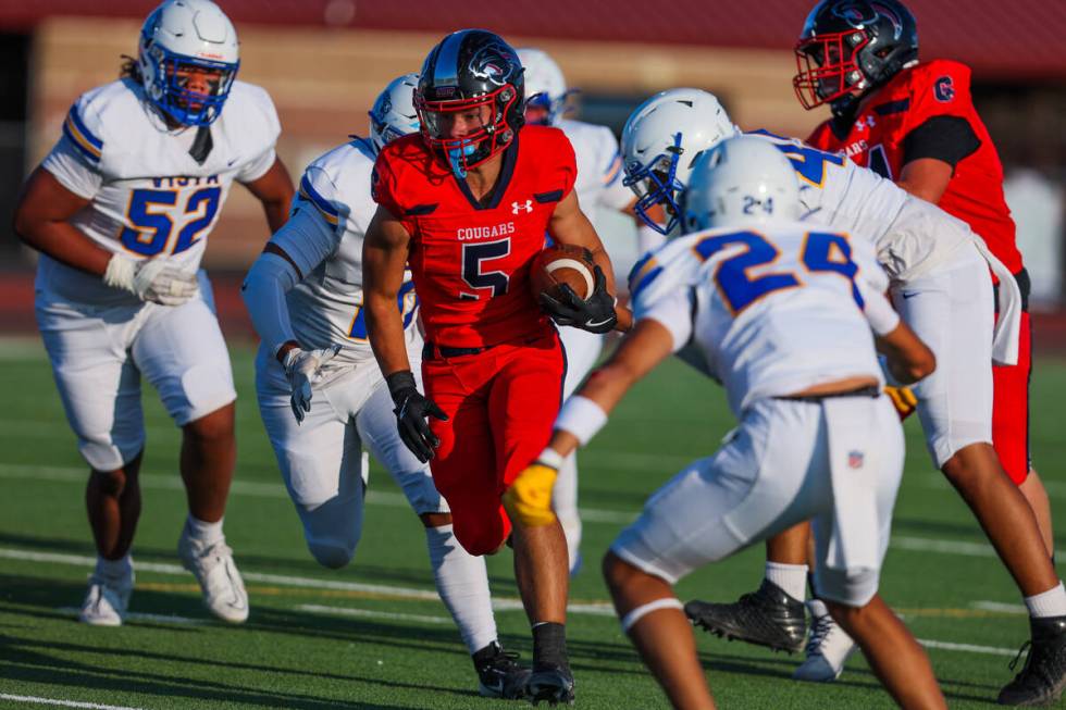 Coronado’s Derek Hurley moves the ball past Sierra Vista defenders during a football gam ...