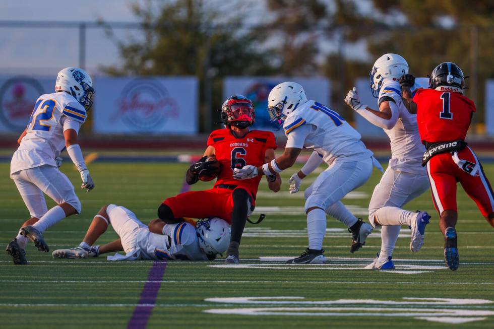 Coronado’s JJ Buchanan (6) goes down with the ball during a football game between Corona ...