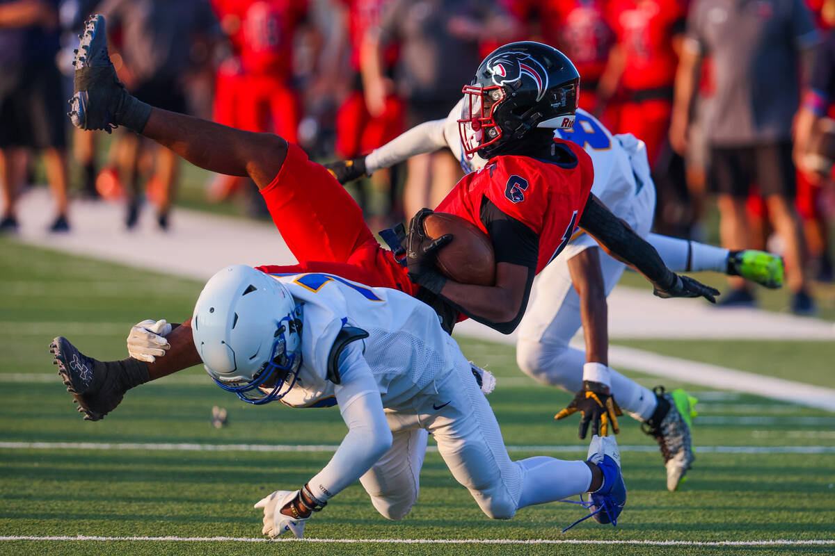 Coronado’s Marquesion Floyde (1) falls as Sierra Vista cornerback Jodi Nestan (12) goes ...