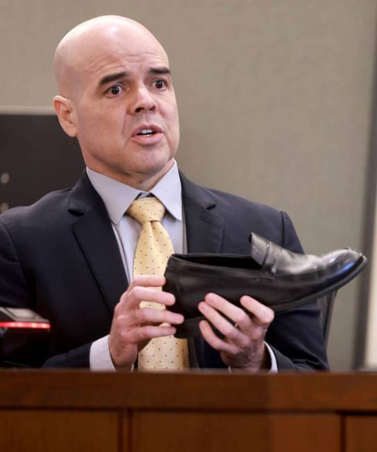 Robert Telles shows that he wears shoe lifts during his narrative on the witness stand on the n ...