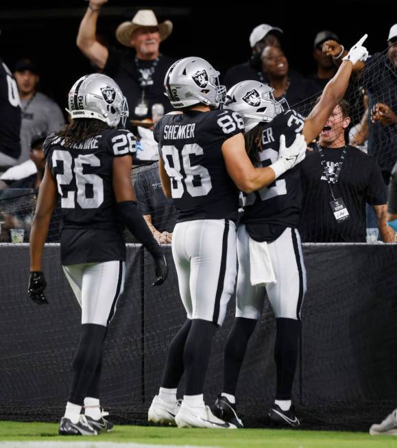 Raiders wide receiver Tyreik McAllister (32) celebrates his punt return touchdown with his team ...