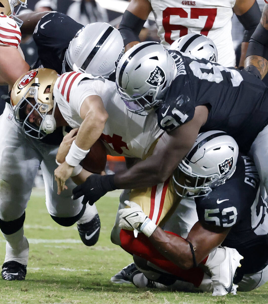 San Francisco 49ers quarterback Tanner Mordecai (4) sacked by Raiders linebacker Amari Gainer ( ...