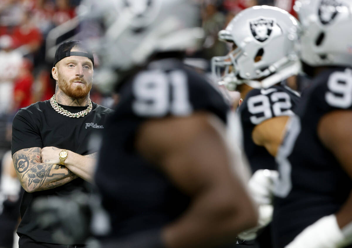 Raiders defensive end Maxx Crosby watches as his teammates warm up to face San Francisco 49ers ...