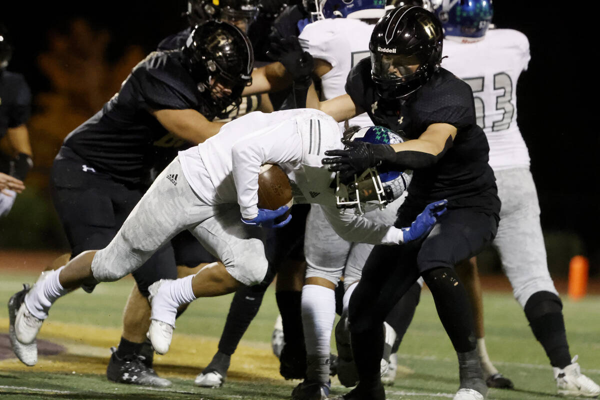 Faith Lutheran's Cole Keith (8) takes down Green Valley's Theo Edquilang (6) during the second ...