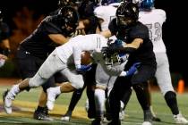 Faith Lutheran's Cole Keith (8) takes down Green Valley's Theo Edquilang (6) during the second ...