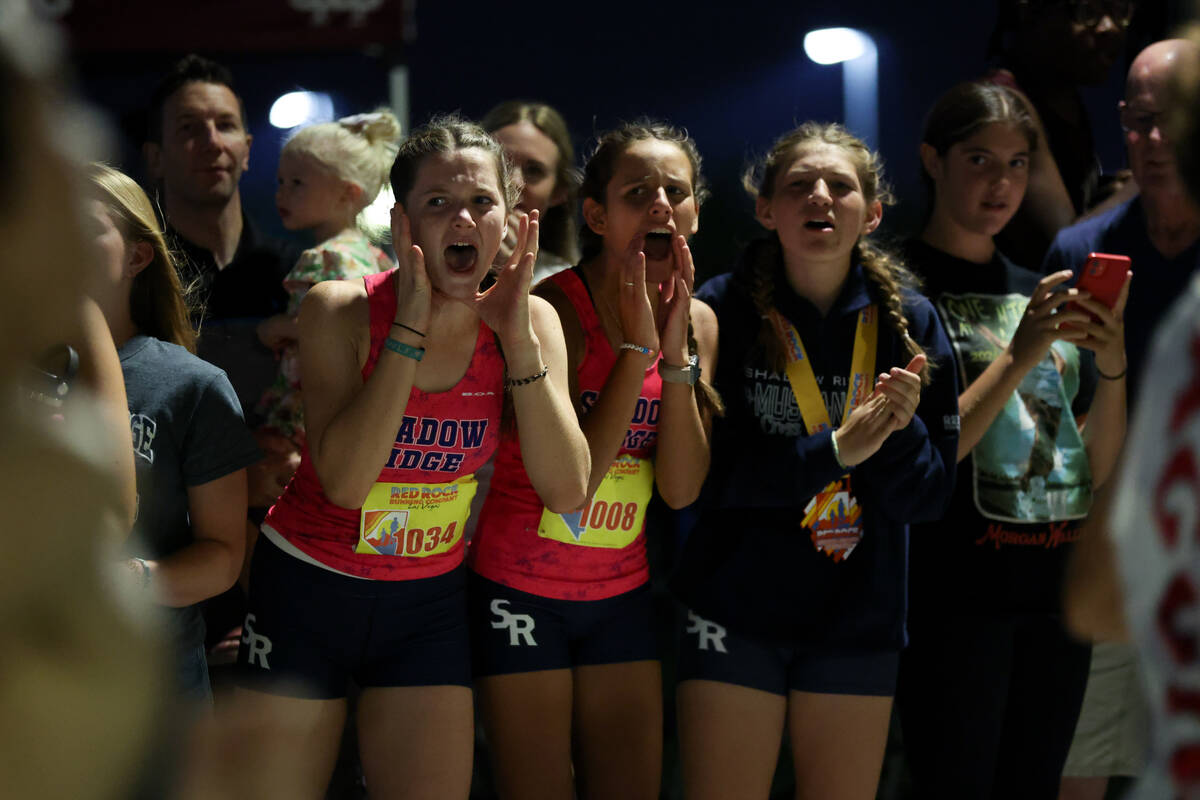 Girls runners cheer for their boy teammates during the Red Rock Running Company Invitational cr ...