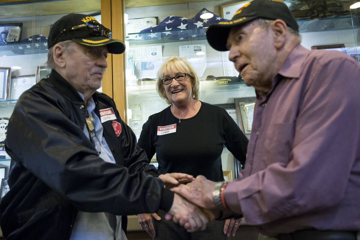 Charm McElree, center, looks at military veterans Norm Johnson, left, and George Markle as they ...