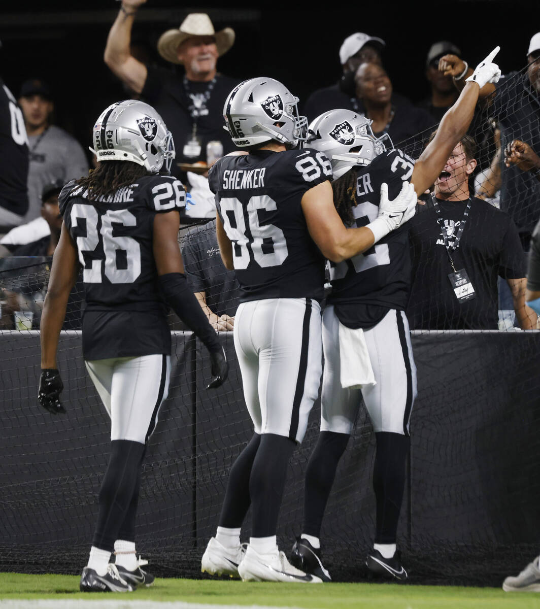 Raiders wide receiver Tyreik McAllister (32) celebrates his punt return touchdown with his team ...