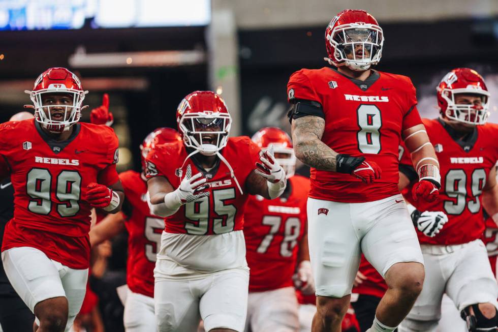 UNLV players run out of the tunnel during the Mountain West championship game at Allegiant Stad ...