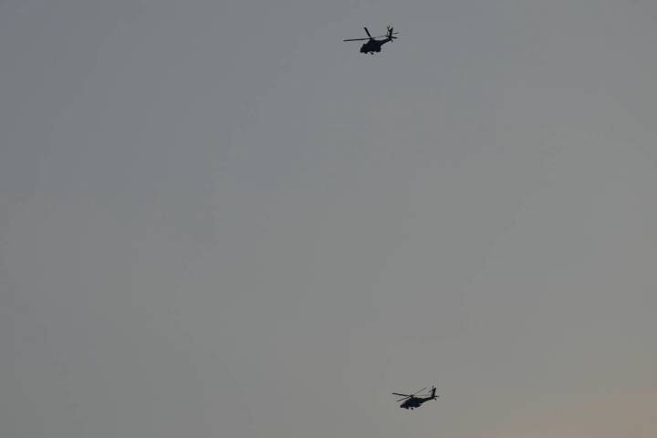 Israeli Apache helicopters fly toward northern Israel, Sunday, Aug. 25, 2024. (AP Photo/Ariel S ...