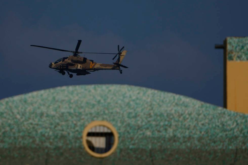 An Israeli Apache helicopter flies over Israel, Sunday, Aug. 25, 2024. (AP Photo/Ariel Schalit)