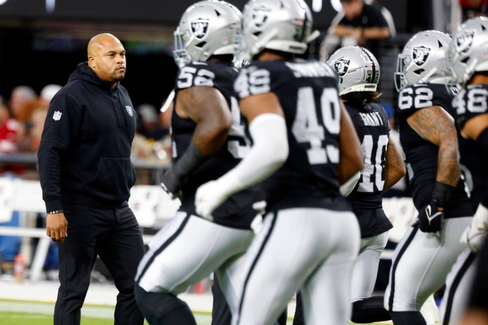 Raiders head coach Antonio Pierce watches as his players warm up to face San Francisco 49ers d ...