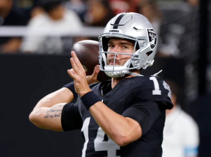 Raiders quarterback Carter Bradley (14) throws the ball as he warms up to face San Francisco 49 ...