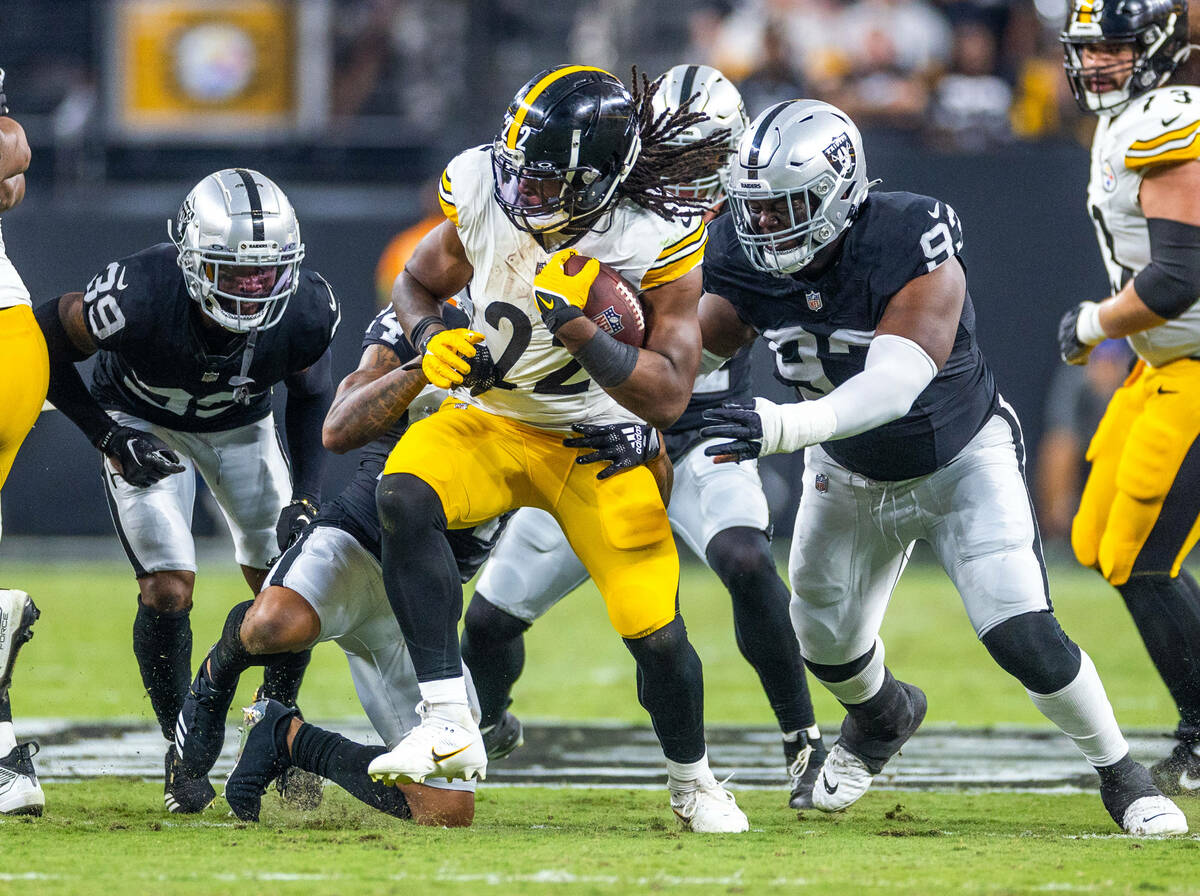 Pittsburgh Steelers running back Najee Harris (22) is tackled by Raiders cornerback Marcus Pete ...