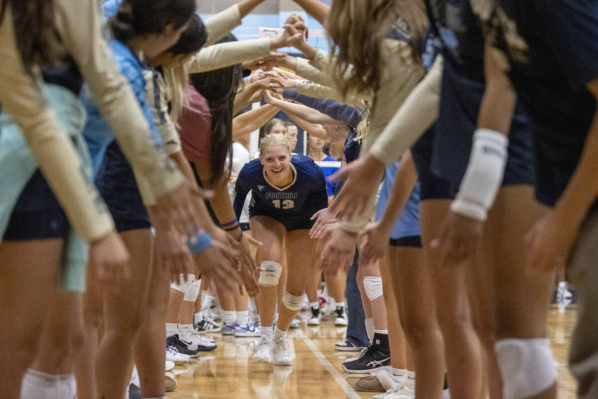 Foothill senior Madelyn Neibaur (13) runs through the team tunnel before the volleyball match a ...